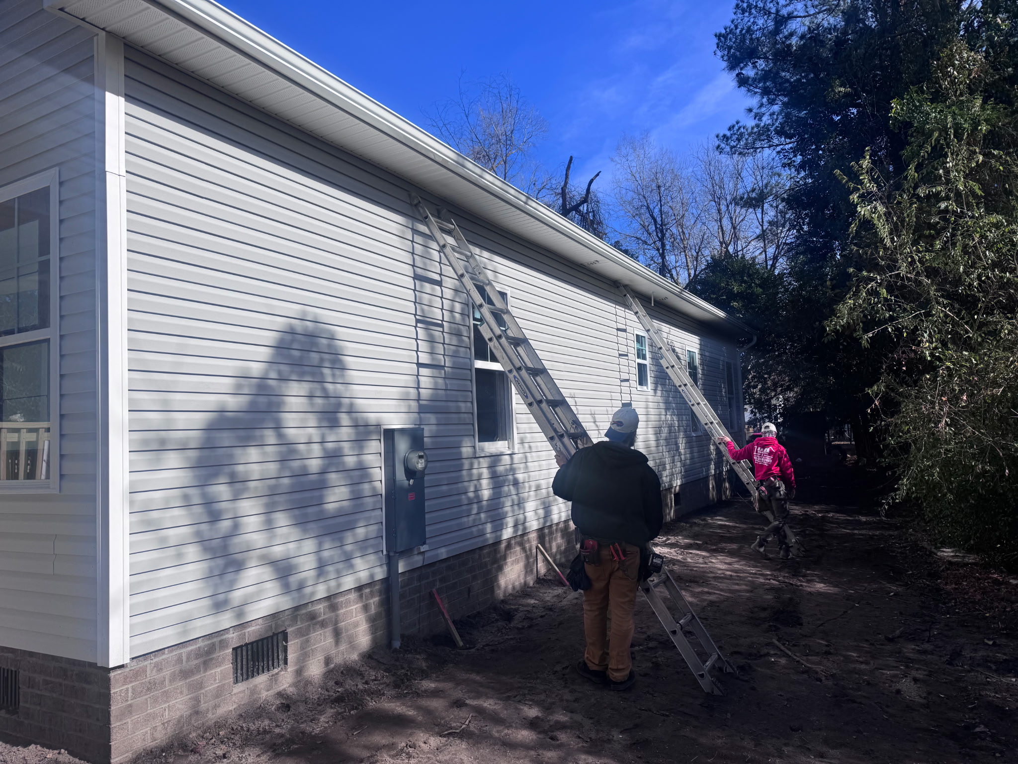 Technician repairing a sagging residential gutter section